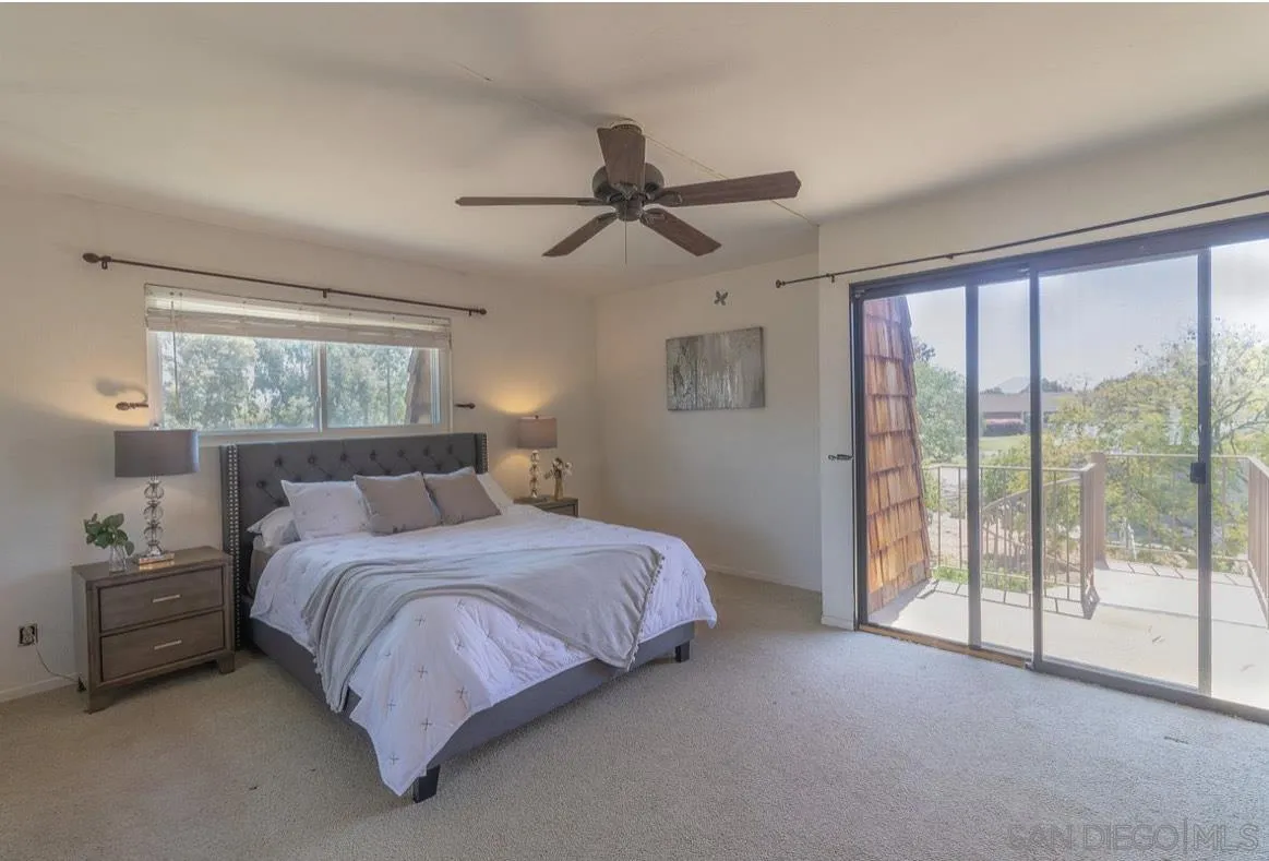 2328 Grace Lane Alpine, CA 91901 - Photo 19 of 27 a bedroom with a bed and large glass window
