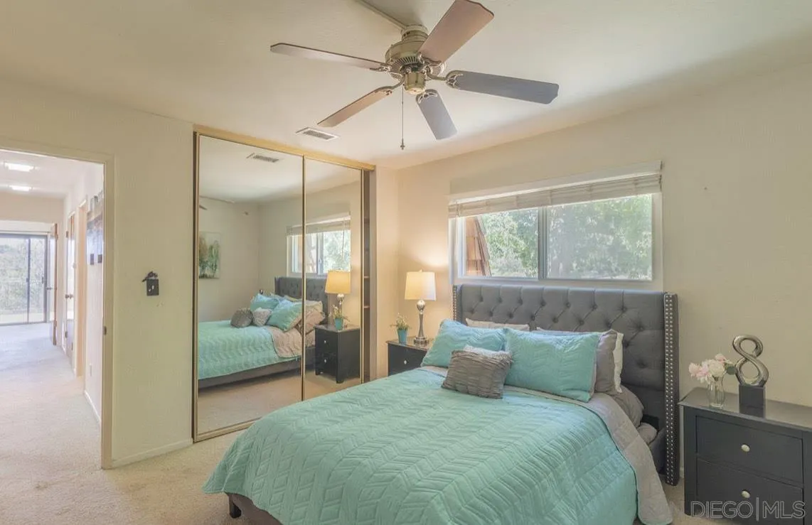 2328 Grace Lane Alpine, CA 91901 - Photo 21 of 27 a bedroom with a balcony a bed and a chandelier