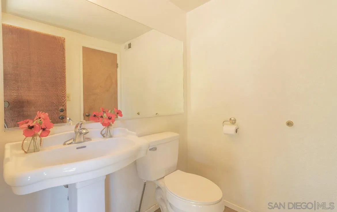 2328 Grace Lane Alpine, CA 91901 - Photo 23 of 27 a bathroom with a sink mirror vanity and toilet