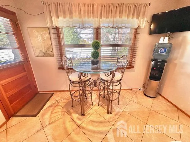 a kitchen with stainless steel appliances granite countertop a refrigerator a sink a stove and chairs