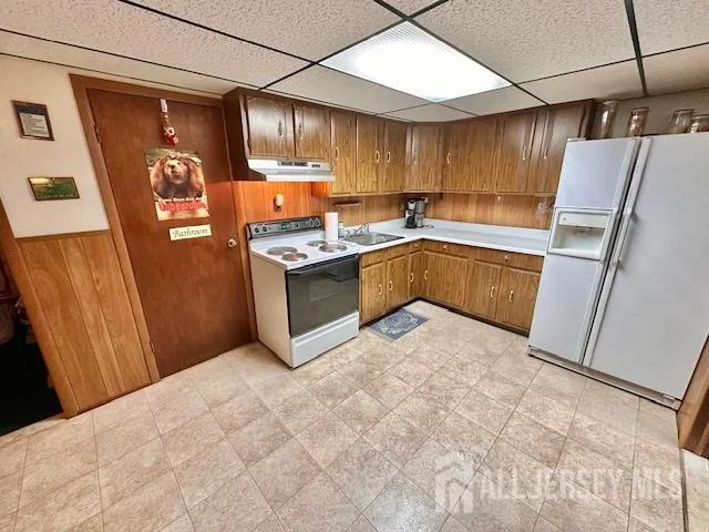 a bathroom with a sink mirror and a shower