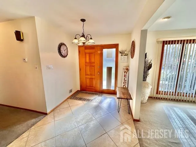 a view of a hallway with entryway wooden floor and door