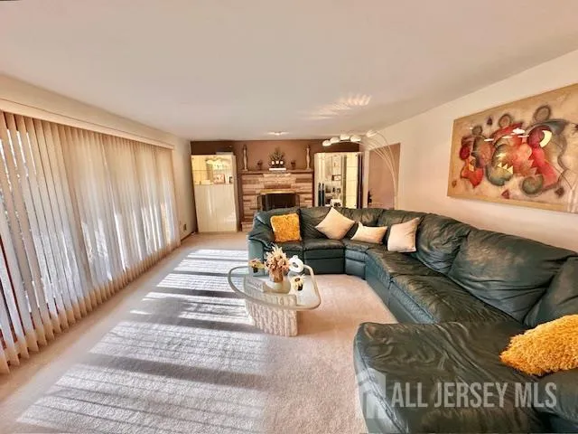 a living room with furniture or couch and a large window