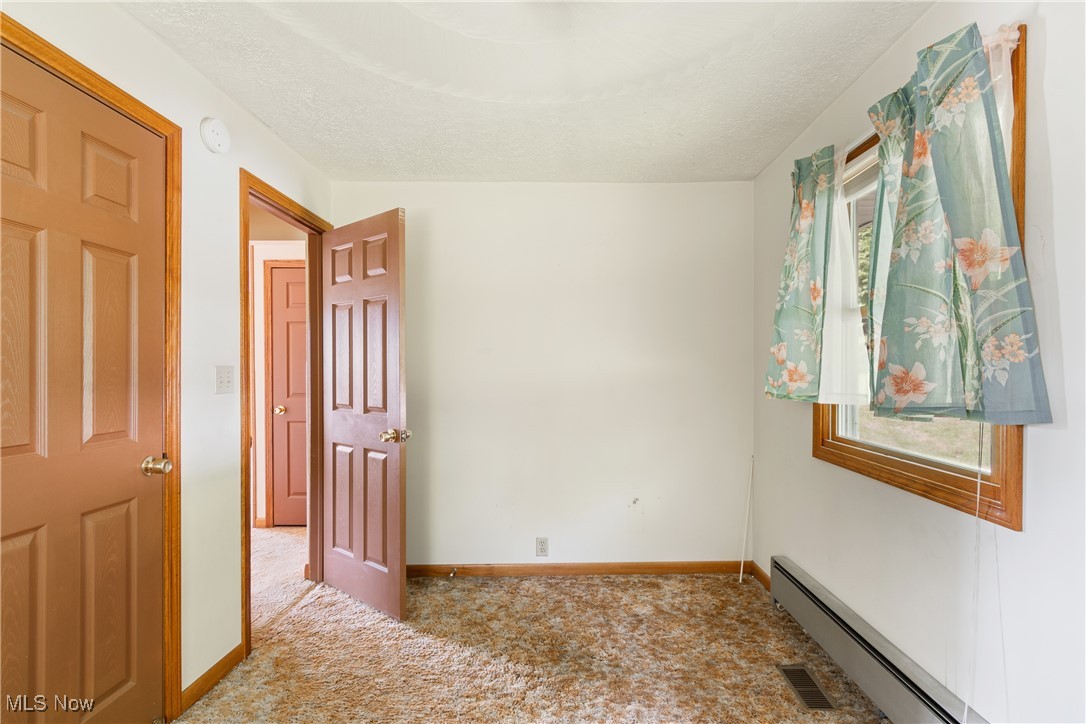 258 Walnut Road Southwest Dellroy, OH 44620 - Photo 17 of 33 Bedroom with multiple windows and carpet flooring