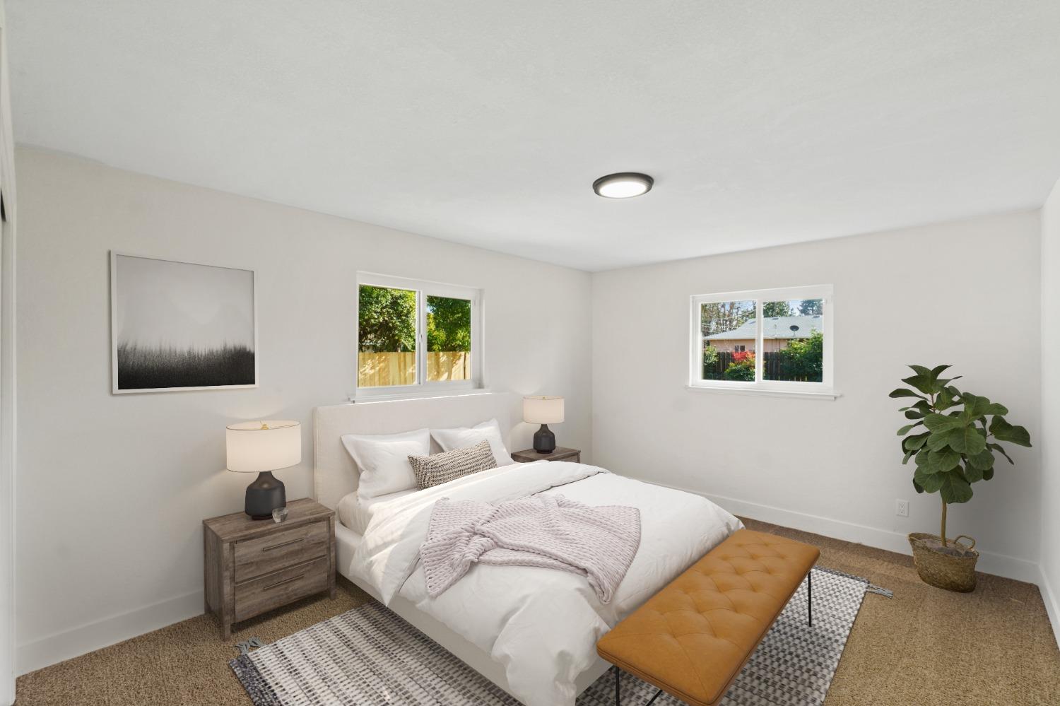 725 West Rialto Avenue Fresno, CA 93705 - Photo 16 of 25 a bedroom with a bed and a potted plant