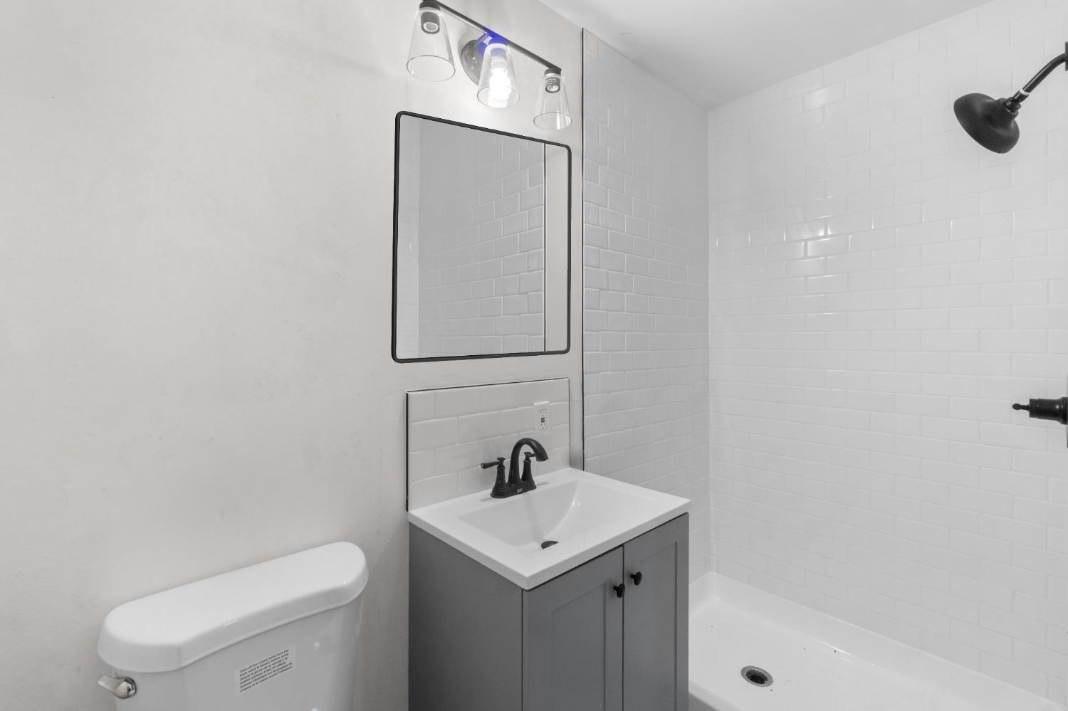 725 West Rialto Avenue Fresno, CA 93705 - Photo 18 of 25 a bathroom with a toilet sink and mirror