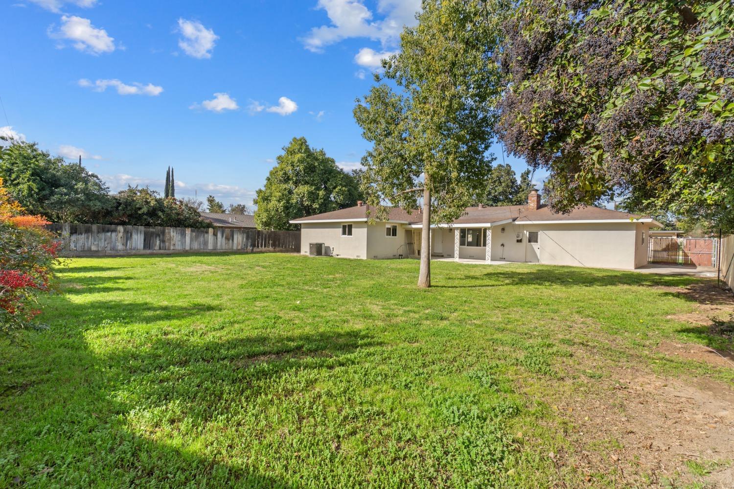 725 West Rialto Avenue Fresno, CA 93705 - Photo 25 of 25 a front view of a house with garden and trees