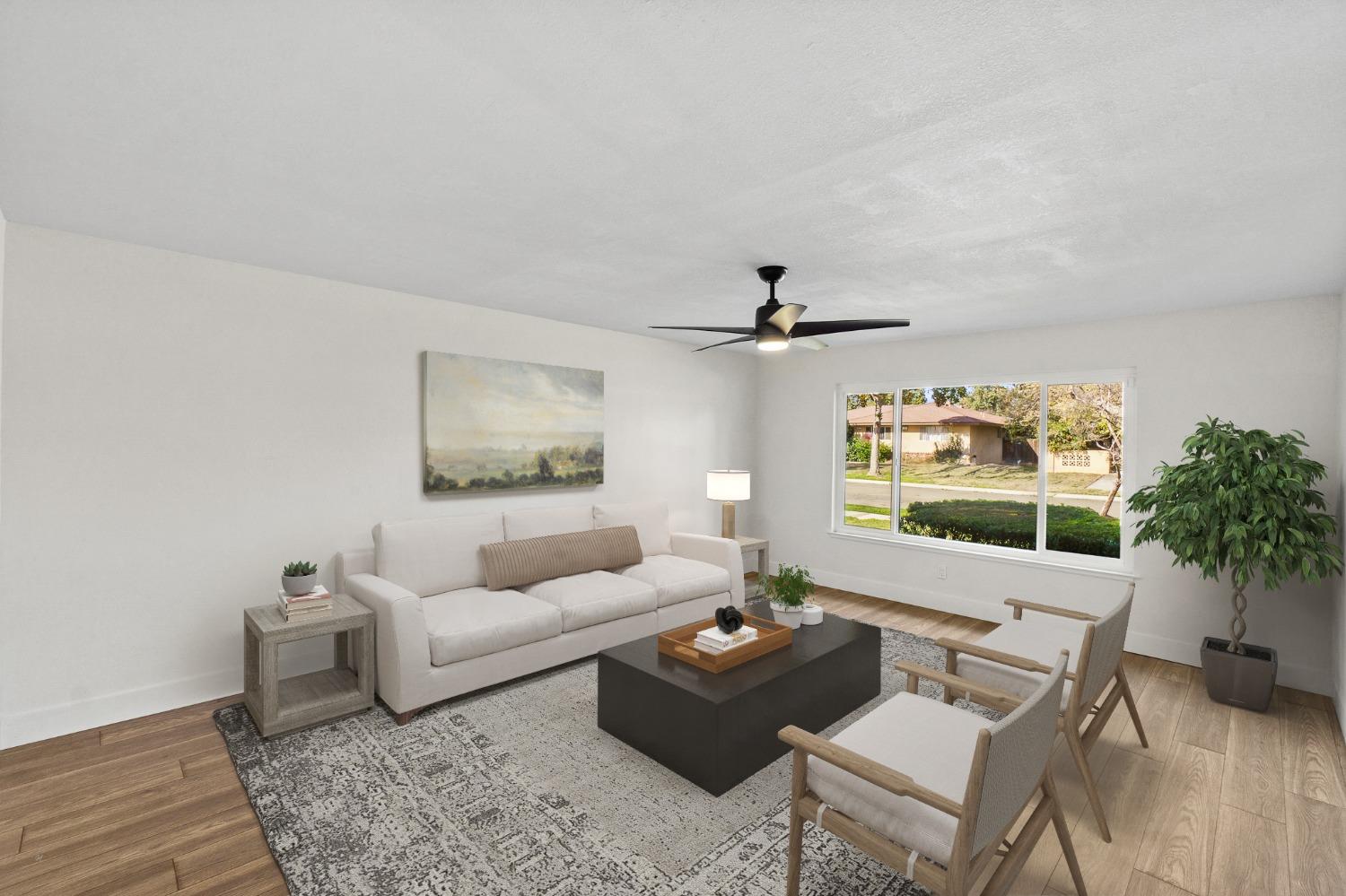 725 West Rialto Avenue Fresno, CA 93705 - Photo 4 of 25 a living room with furniture and a large window