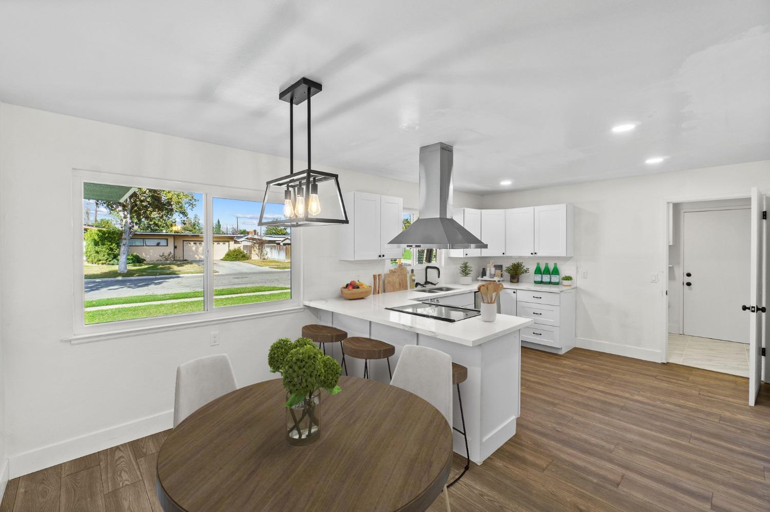 725 West Rialto Avenue Fresno, CA 93705 - Photo 6 of 25 a kitchen with a stove and a wooden floor