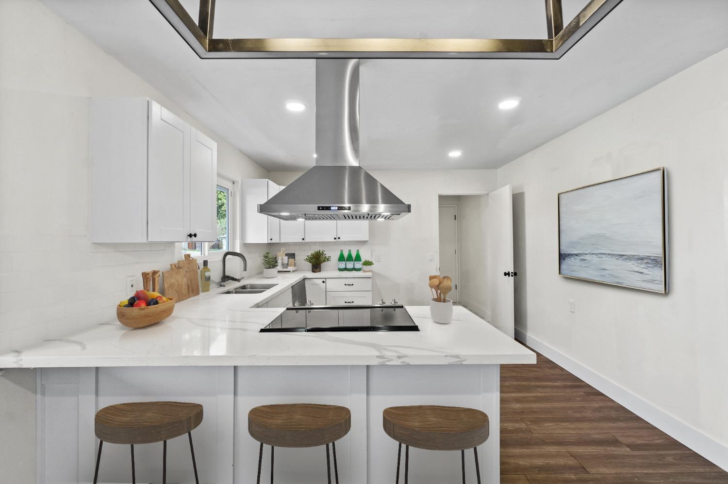 725 West Rialto Avenue Fresno, CA 93705 - Photo 7 of 25 a kitchen with a dining table chairs cabinets and wooden floor