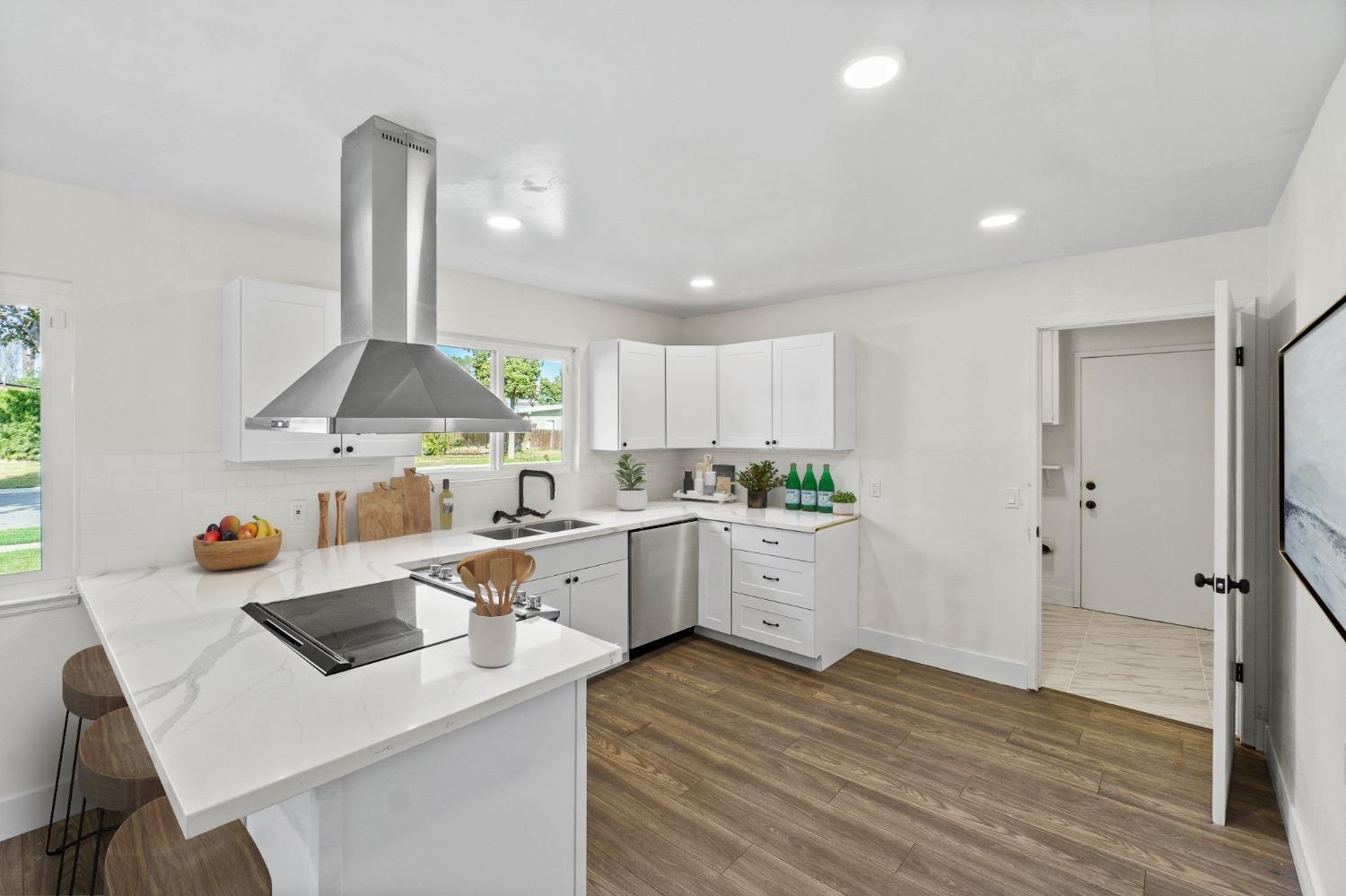 725 West Rialto Avenue Fresno, CA 93705 - Photo 8 of 25 a kitchen with a sink a stove a refrigerator and cabinets