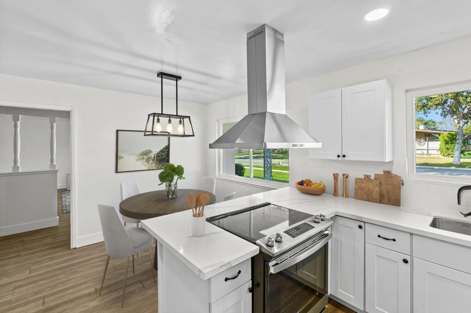725 West Rialto Avenue Fresno, CA 93705 - Photo 9 of 25 a kitchen with a table chairs stove and cabinets