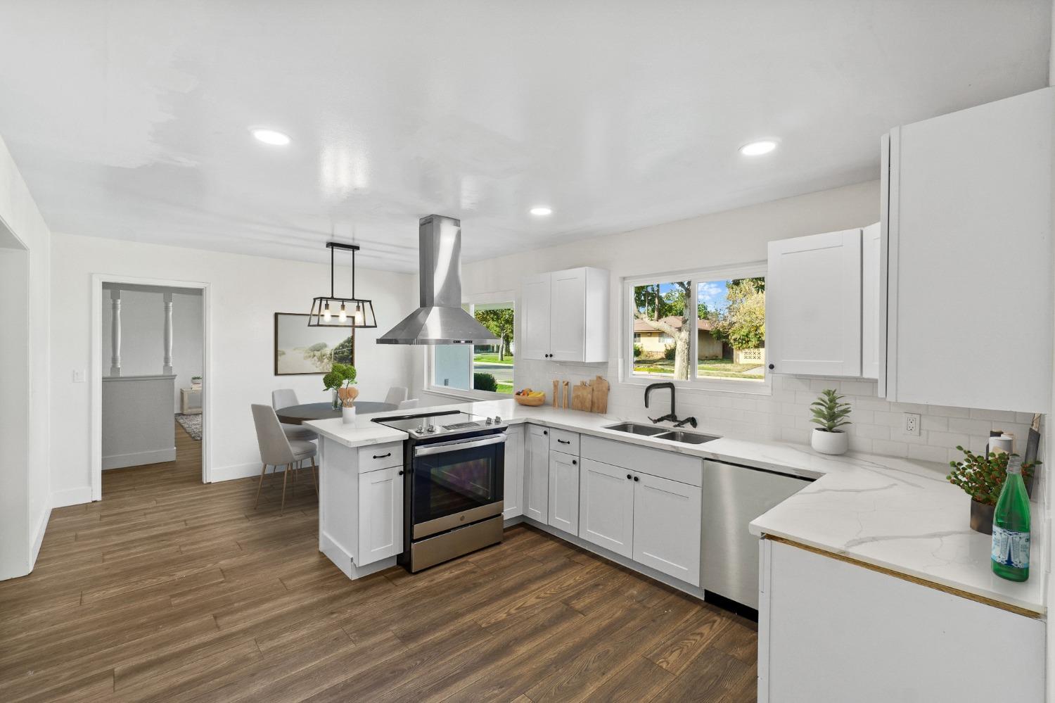 725 West Rialto Avenue Fresno, CA 93705 - Photo 10 of 25 a kitchen with stainless steel appliances granite countertop a sink stove and refrigerator