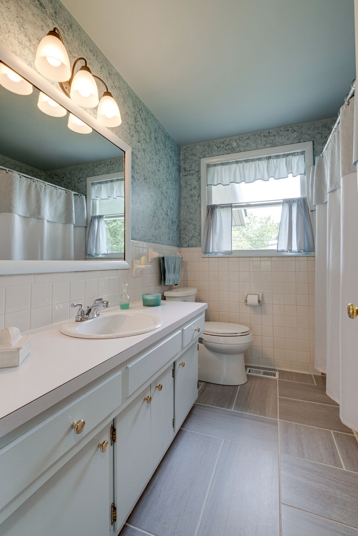 3021 Anderson Road Nashville, TN 37217 - Photo 13 of 27 a bathroom with a toilet a sink and mirror