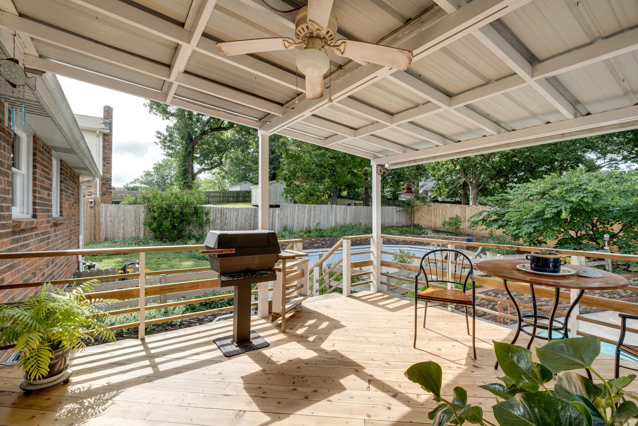 3021 Anderson Road Nashville, TN 37217 - Photo 24 of 27 a view of a patio with table and chairs potted plants with wooden floor and fence