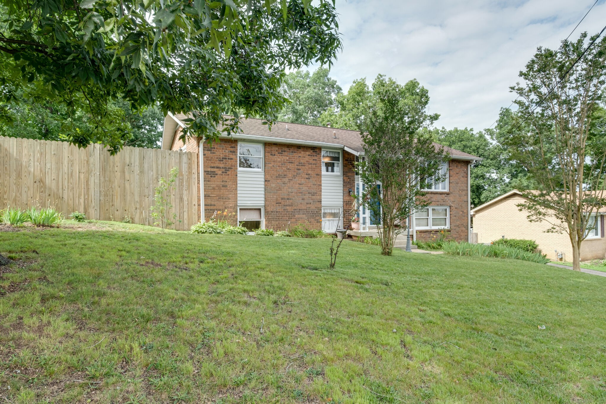 3021 Anderson Road Nashville, TN 37217 - Photo 3 of 27 a view of a backyard with large trees and plants
