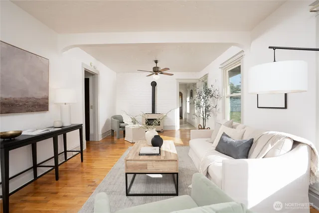 a living room with furniture and a wooden floor
