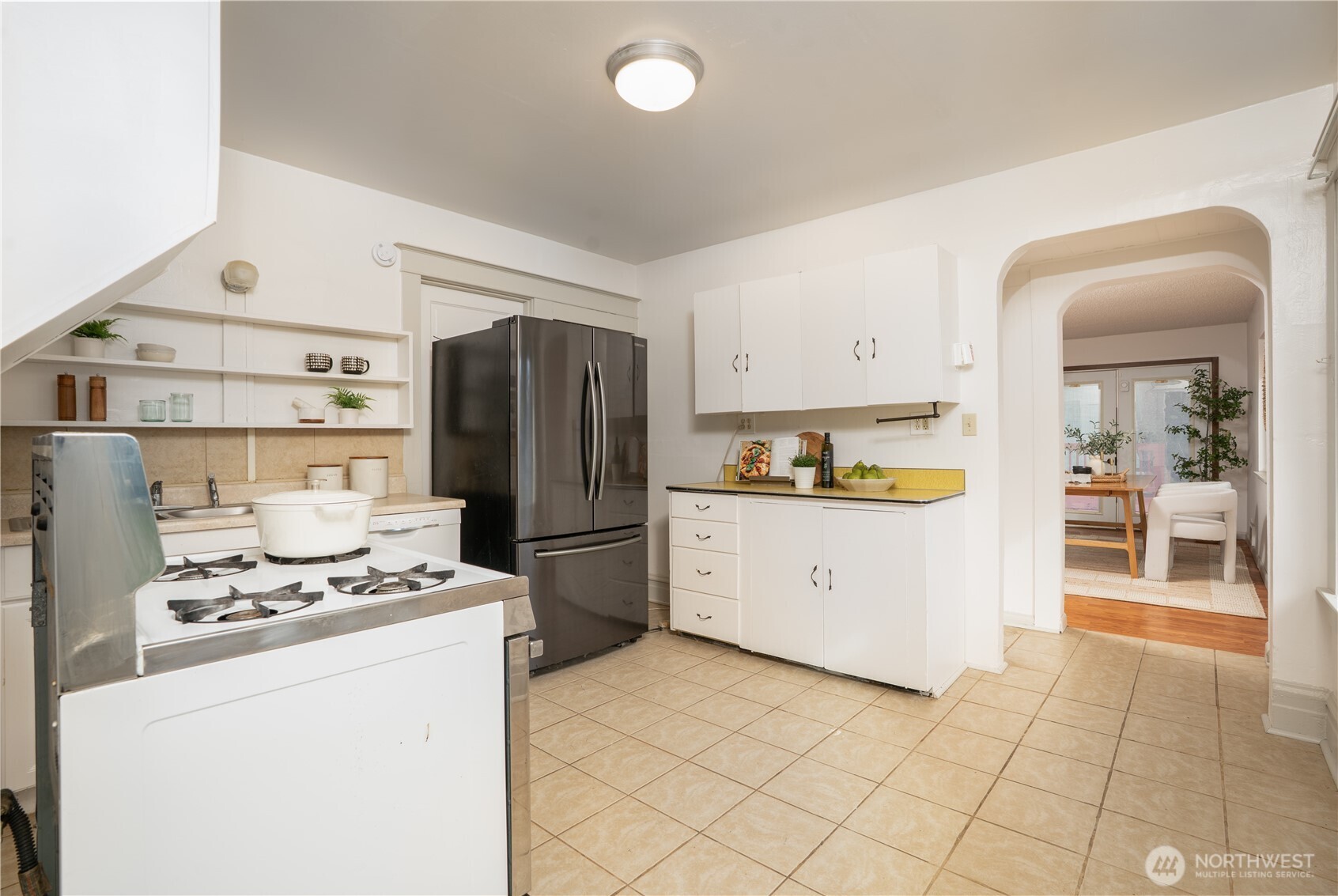 205 Brandywine Avenue DuPont, WA 98327 - Photo 13 of 38 a kitchen with a refrigerator a stove and white cabinets