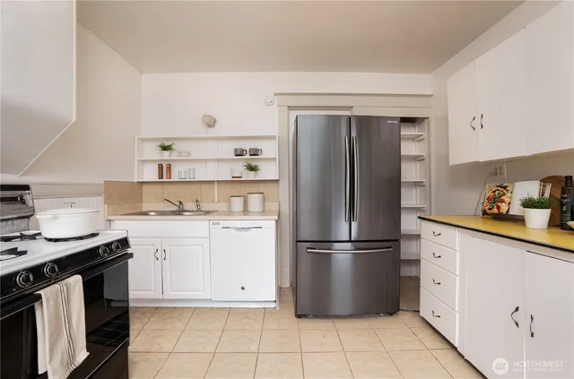 a kitchen with stainless steel appliances granite countertop a refrigerator sink and stove