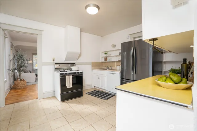 a kitchen with a refrigerator sink and cabinets