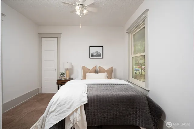 a bedroom with a bed and a chandelier