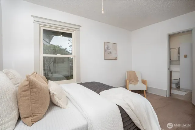 a bedroom with a bed and a mirror