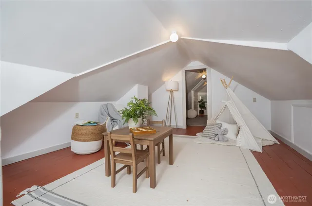 a dining room with furniture and potted plants