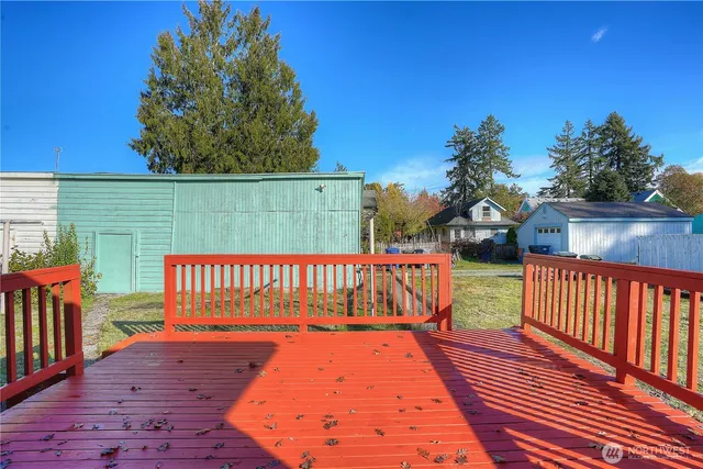 a street view with wooden fence and trees