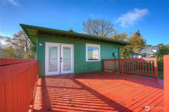a view of backyard with a deck and wooden floor