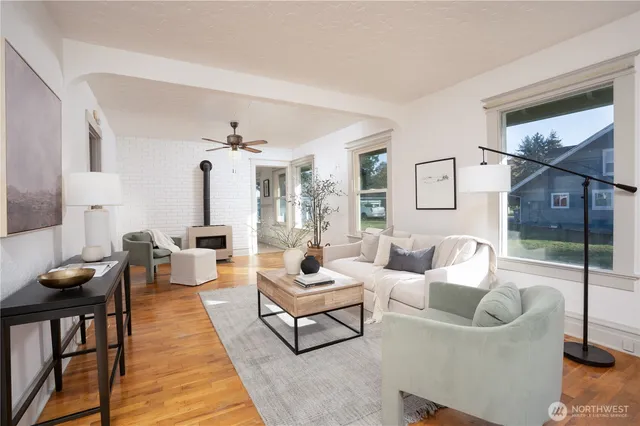 a living room with furniture and wooden floor