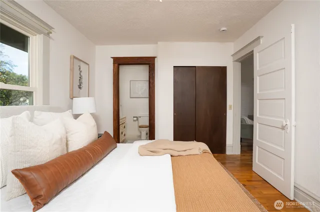 a bedroom with a bed and a large window