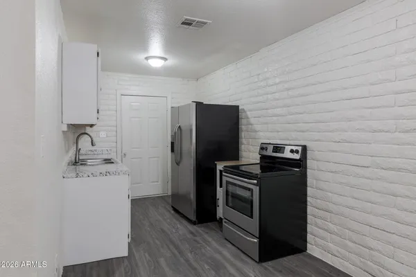 a kitchen with stainless steel appliances a refrigerator and a stove