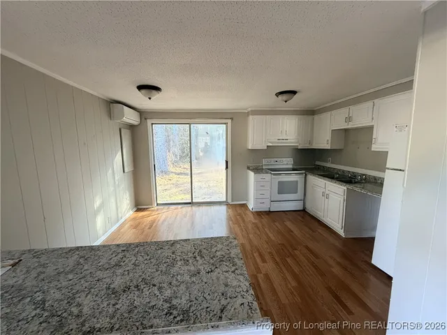 a large kitchen with a stove a sink dishwasher and a refrigerator