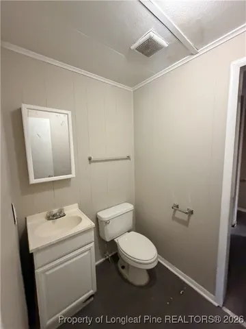 a bathroom with a toilet a sink a shower and mirror