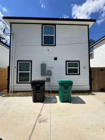 a front view of a house with outdoor seating