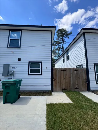 a view of a room with a ceiling fan and hardwood floor