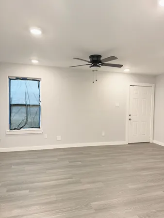 a view of a room with wooden floor