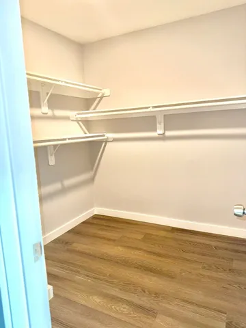 a view of a room with wooden floor