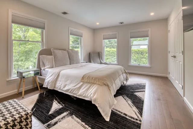 a bed sitting in a bedroom next to a window