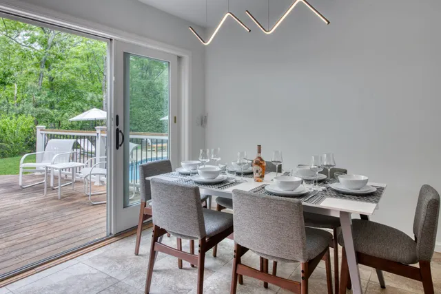 a view of a dining room that has a table and chairs in it
