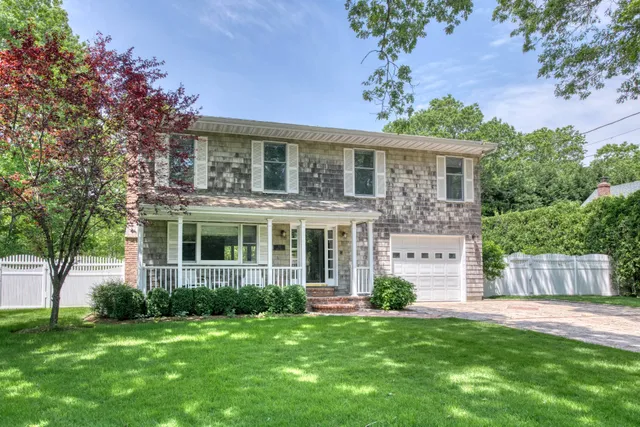 a front view of a house with a garden
