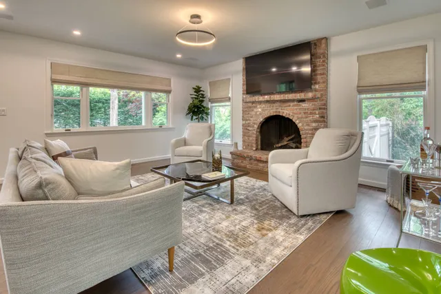 a living room with furniture fireplace and window