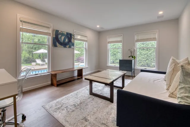 a view of a livingroom with furniture and a window