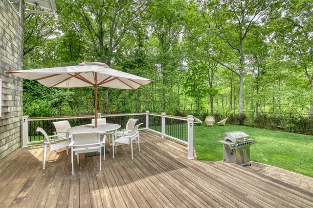 a balcony with table and chairs