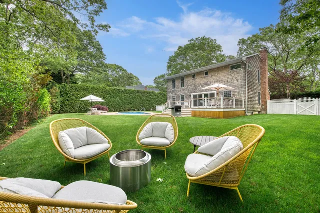 an outdoor living space with furniture and garden view