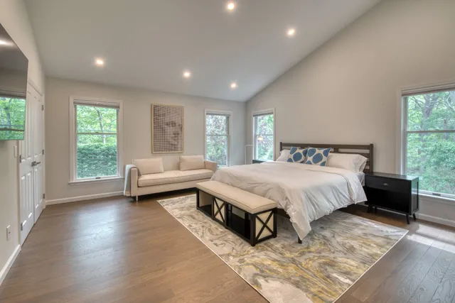 a spacious bedroom with a bed and a couch