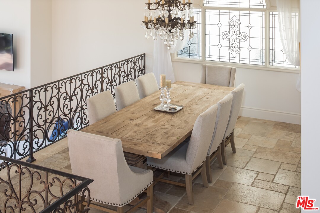 129 Roma Court Marina del Rey, CA 90292 - Photo 11 of 42 a view of a dining room with furniture and chandelier