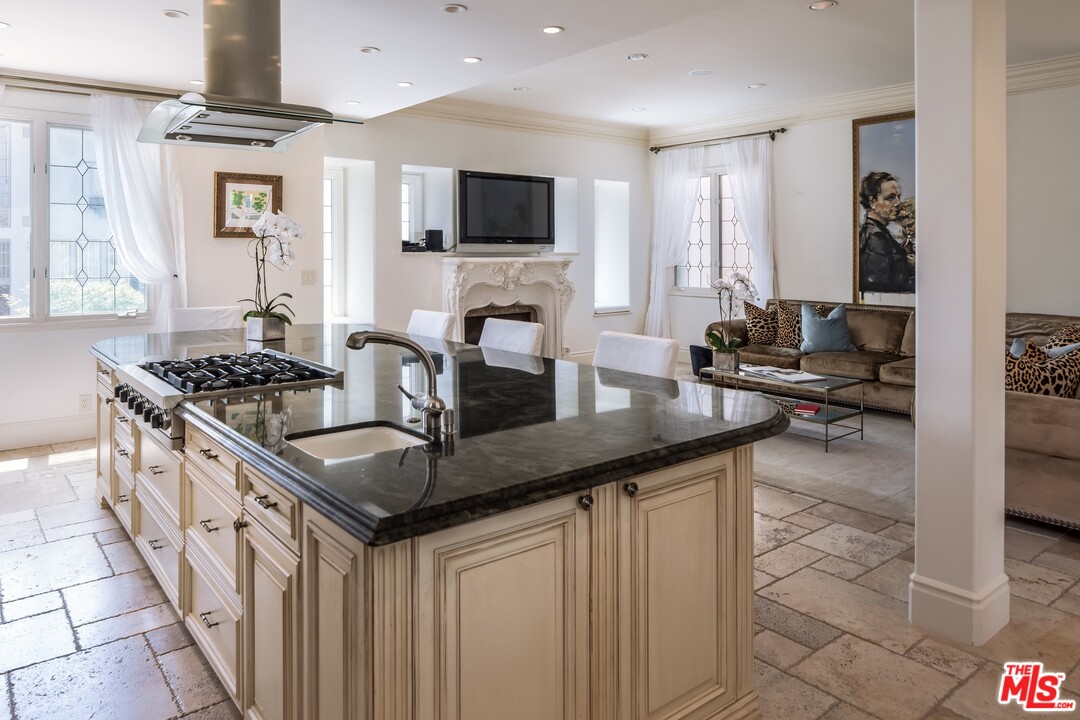129 Roma Court Marina del Rey, CA 90292 - Photo 13 of 42 a kitchen with granite countertop a sink stove and cabinets