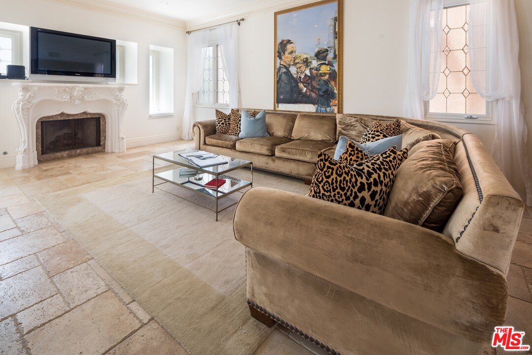 129 Roma Court Marina del Rey, CA 90292 - Photo 19 of 42 a living room with furniture a fireplace and a flat screen tv