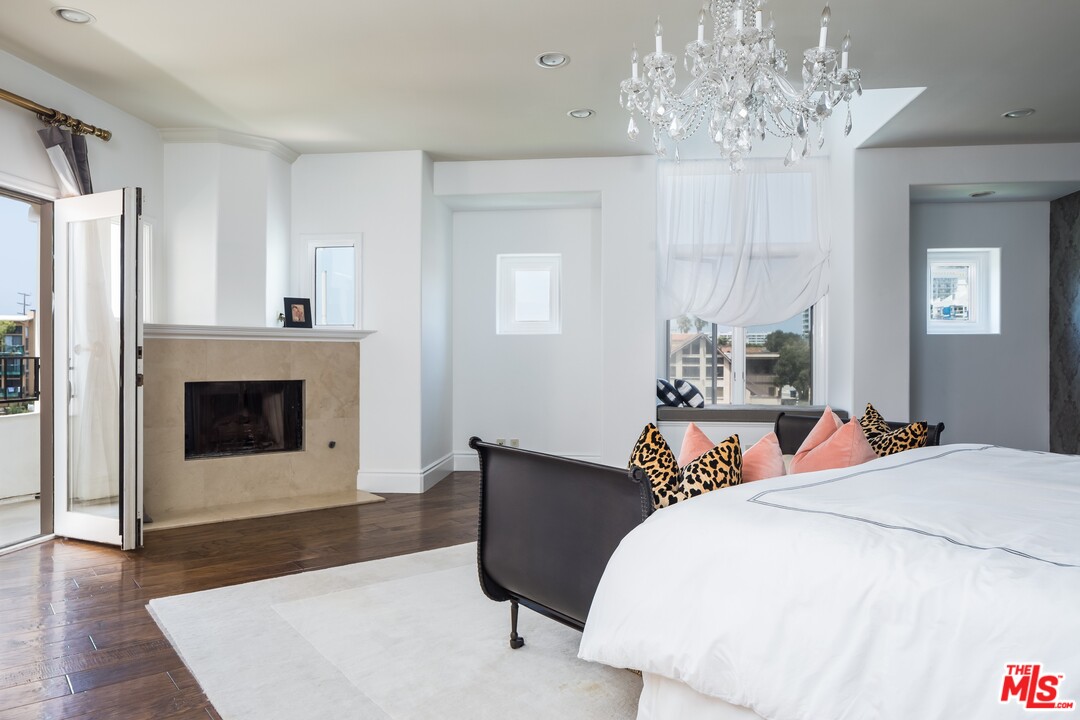 129 Roma Court Marina del Rey, CA 90292 - Photo 22 of 42 a bedroom with a bed and a fireplace